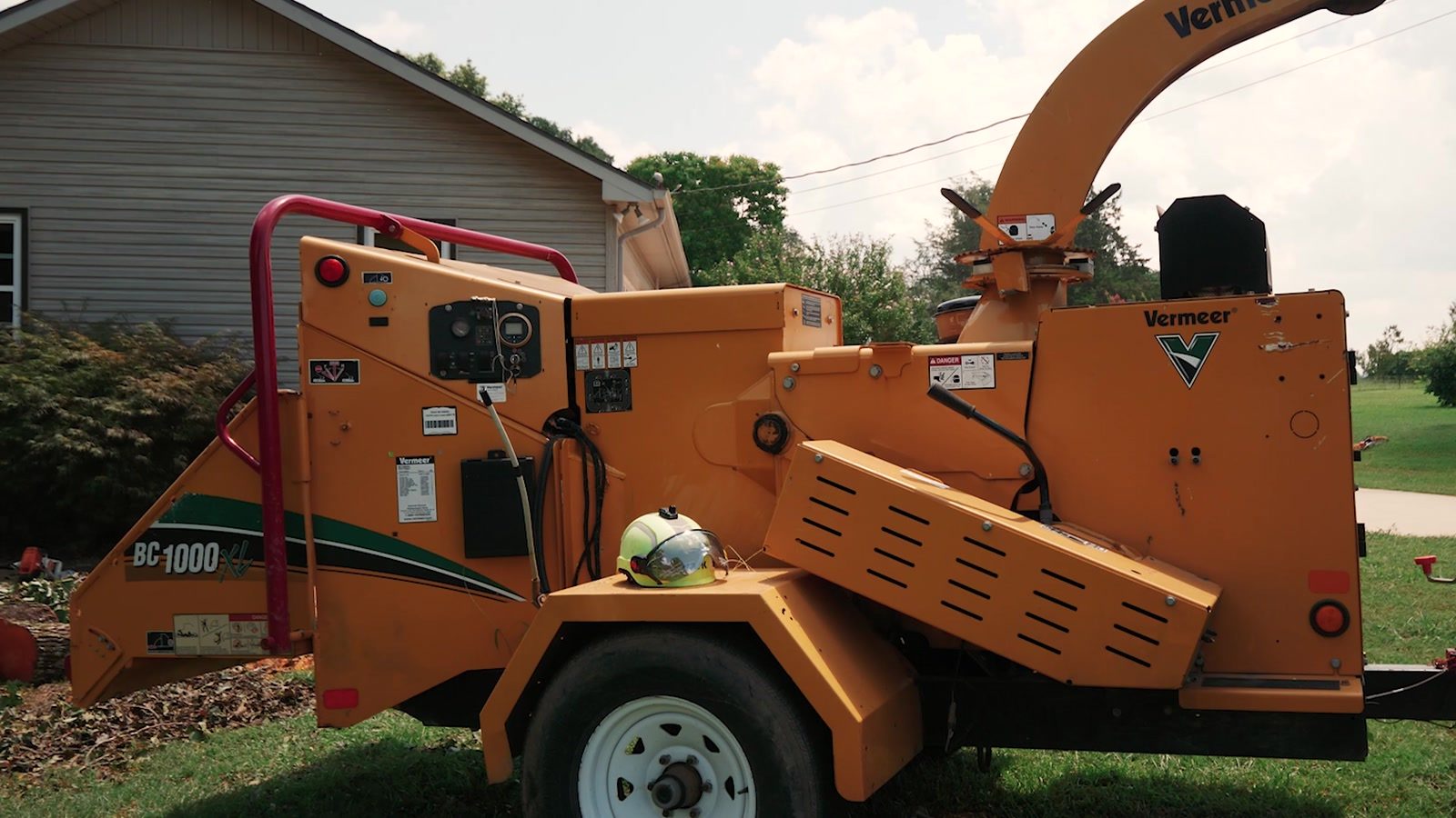 Chipper set up beside a house on a residential tree removal in Alabama